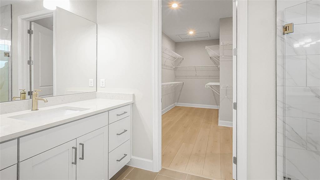 1620 Bellagio Loop Tavares, FL 32778 - Photo 44 of 81 a bathroom with a shower sink and mirror