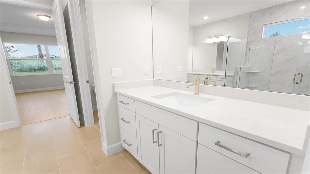 1620 Bellagio Loop Tavares, FL 32778 - Photo 48 of 81 a bathroom with a sink a vanity a shower and a mirror