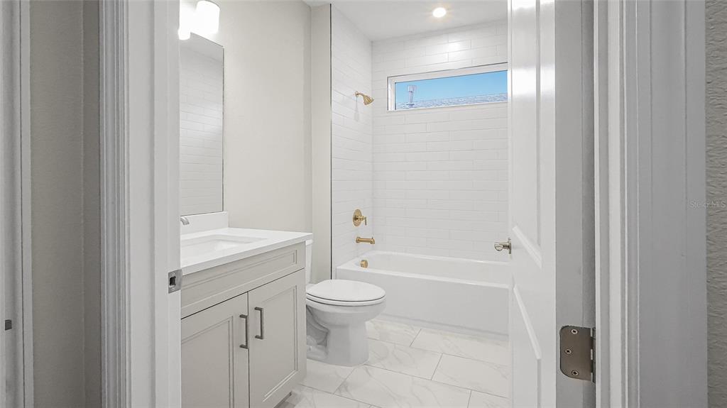 1620 Bellagio Loop Tavares, FL 32778 - Photo 53 of 81 a bathroom with a granite countertop sink a toilet and shower