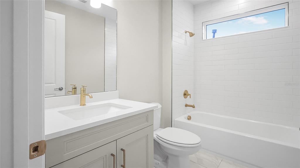 1620 Bellagio Loop Tavares, FL 32778 - Photo 54 of 81 a bathroom with a sink a toilet and a mirror