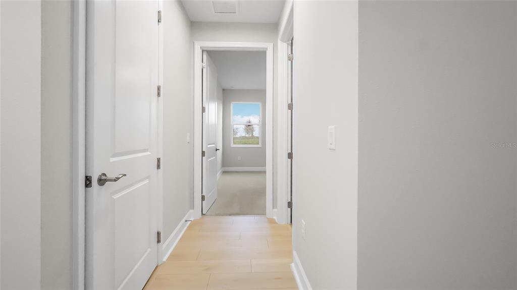1620 Bellagio Loop Tavares, FL 32778 - Photo 6 of 81 a view of a bathroom from a hallway with toilet