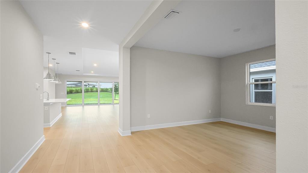 1620 Bellagio Loop Tavares, FL 32778 - Photo 7 of 81 a view of an empty room with a floor to ceiling window and a yard