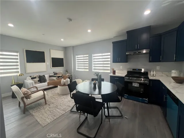 a kitchen with a sink dining table and chairs