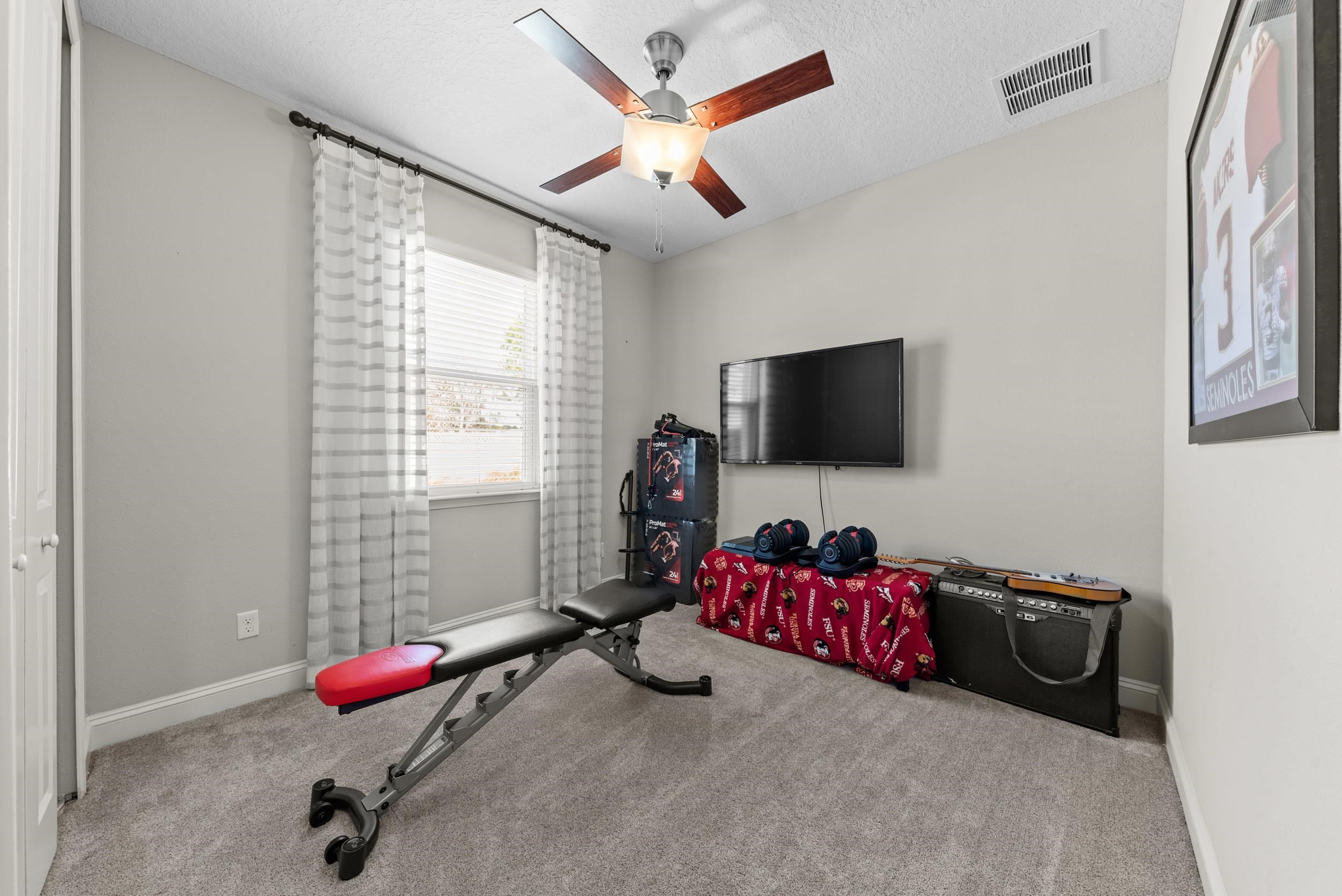 55 Lansing Court St. Augustine, FL 32092 - Photo 26 of 42 a room with gym equipment and a flat screen tv