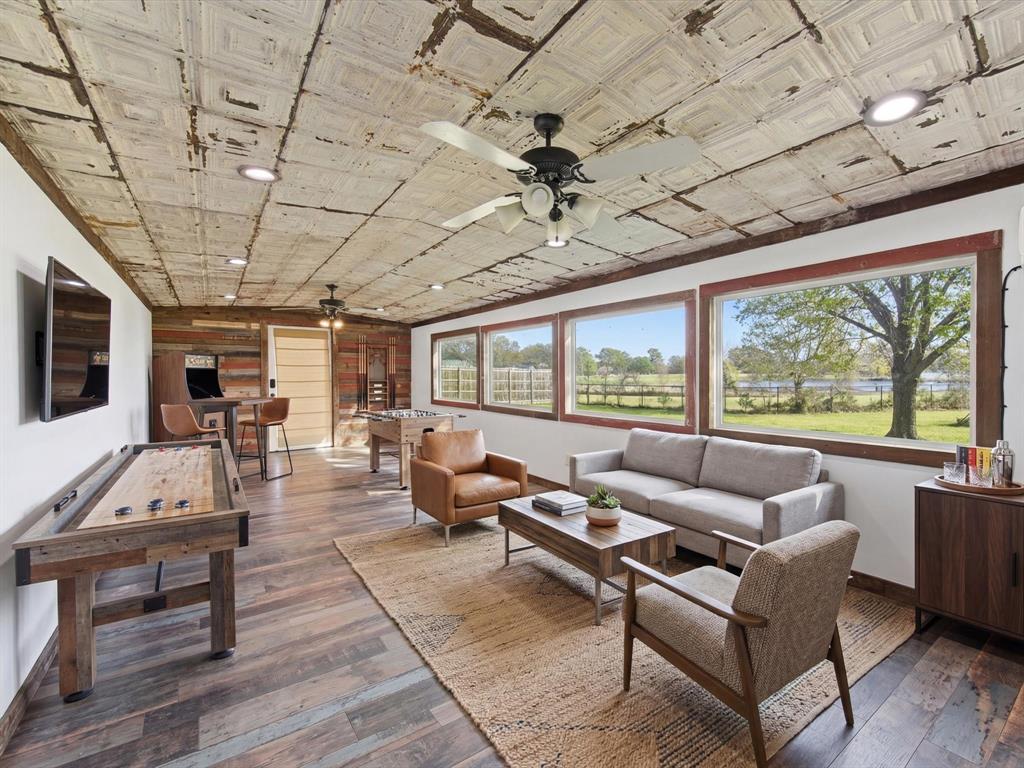 116 County Road 1559 Alba, TX 75410 - Photo 12 of 40 a living room with furniture large windows and wooden floor