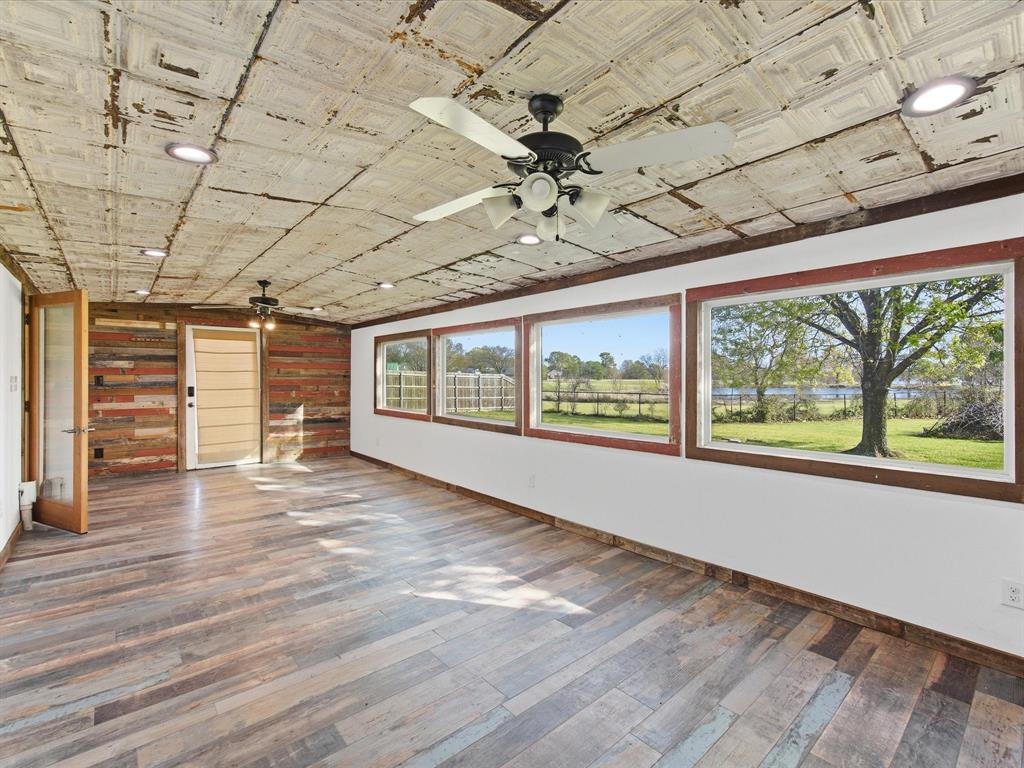 116 County Road 1559 Alba, TX 75410 - Photo 13 of 40 a view of an empty room with a window and wooden floor