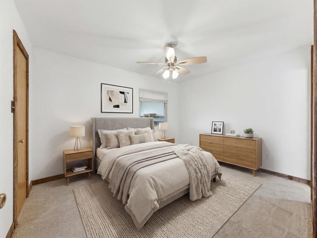116 County Road 1559 Alba, TX 75410 - Photo 16 of 40 a spacious bedroom with a bed and a chandelier