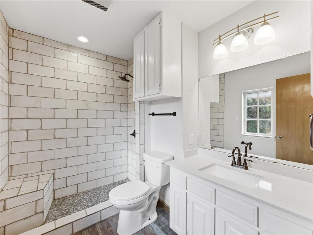 116 County Road 1559 Alba, TX 75410 - Photo 18 of 40 a bathroom with a sink a toilet and shower