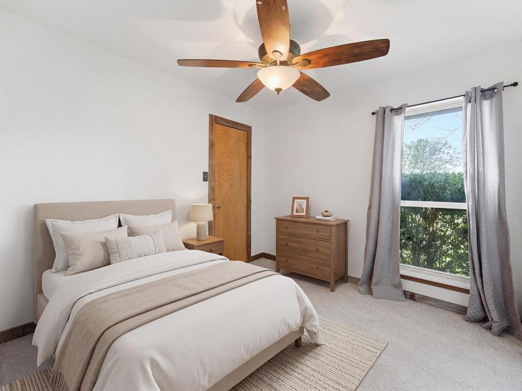 116 County Road 1559 Alba, TX 75410 - Photo 19 of 40 a bedroom with a bed and a chandelier