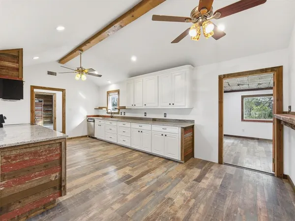 a large kitchen with kitchen island a sink stainless steel appliances and cabinets