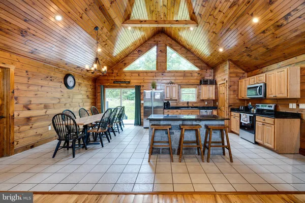 a large kitchen with stainless steel appliances granite countertop a stove and a cabinets