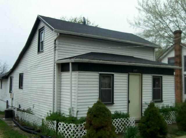 a front view of a house with plants