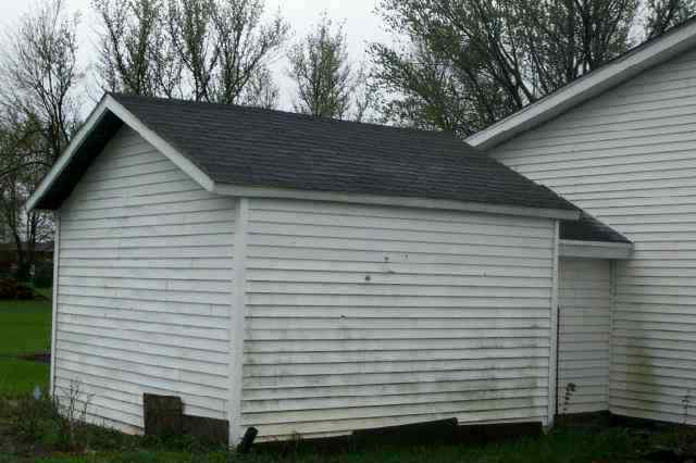 207 Washington Street Ridott, IL 61067 - Photo 4 of 8 a view of a white house with a small space