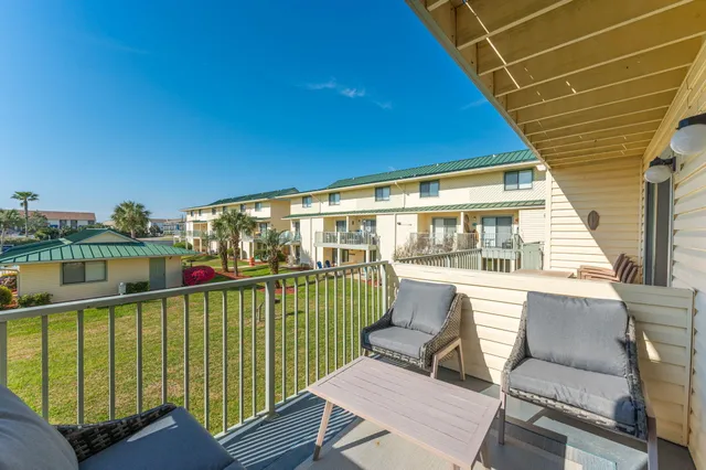 a view of a balcony with furniture