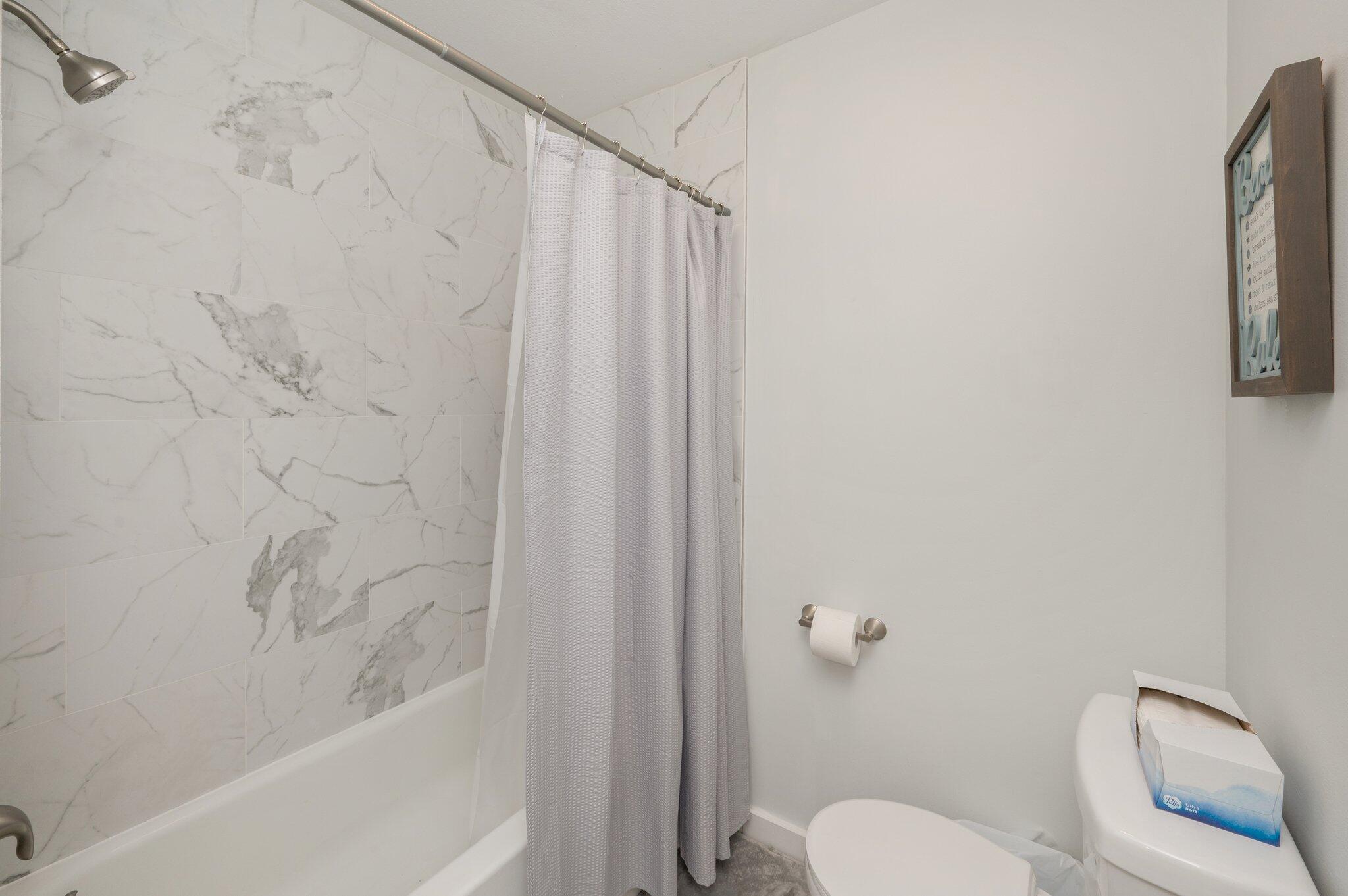 60 Sandprints Drive, Unit C6 Miramar Beach, FL 32550 - Photo 19 of 28 a bathroom with a toilet and a shower curtain