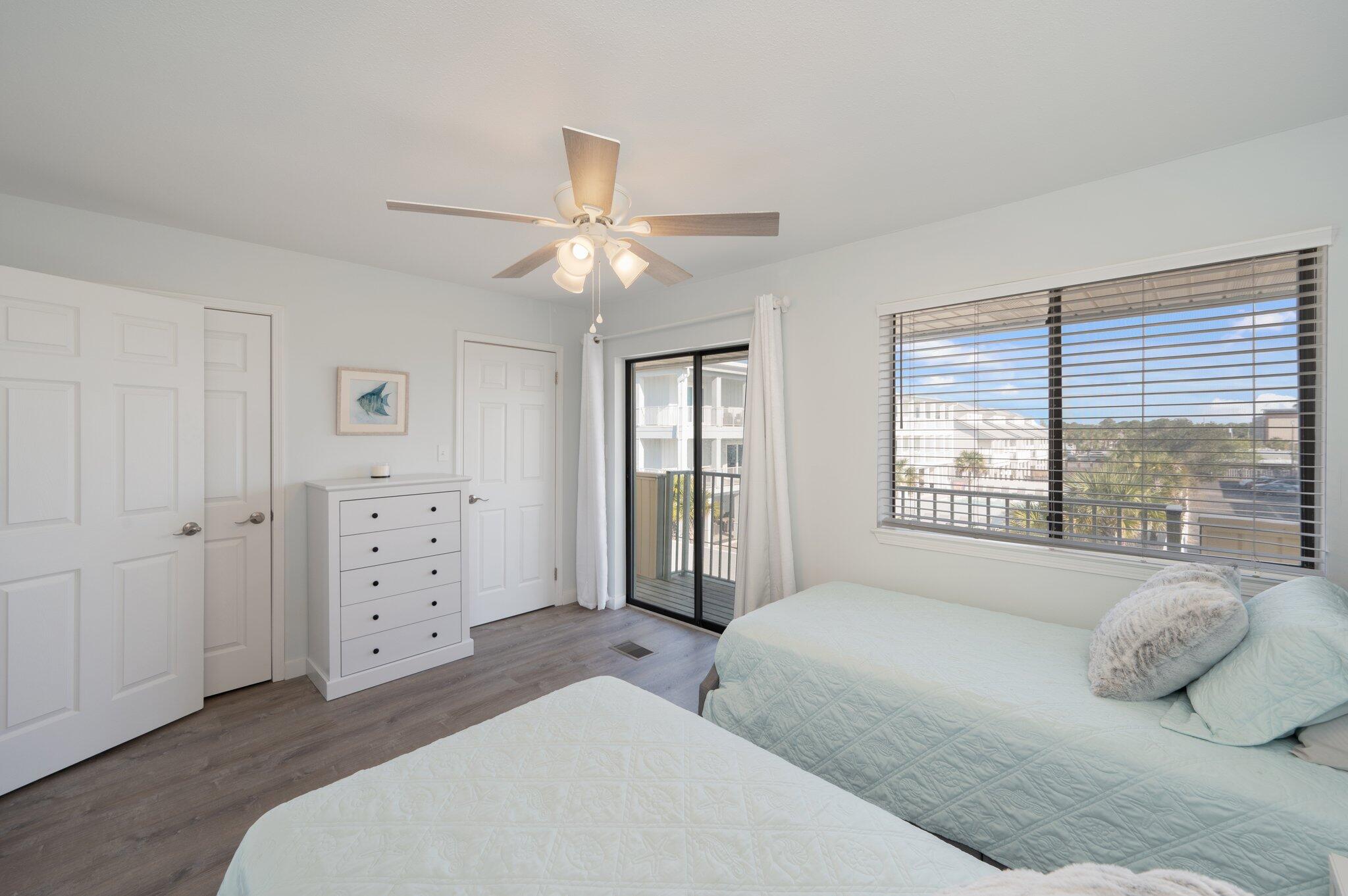 60 Sandprints Drive, Unit C6 Miramar Beach, FL 32550 - Photo 25 of 28 a spacious bedroom with a large bed and a chandelier
