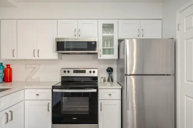 a white refrigerator freezer and a stove sitting inside of a kitchen