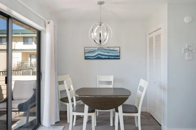 a view of a dining room with furniture wooden floor and a chandelier