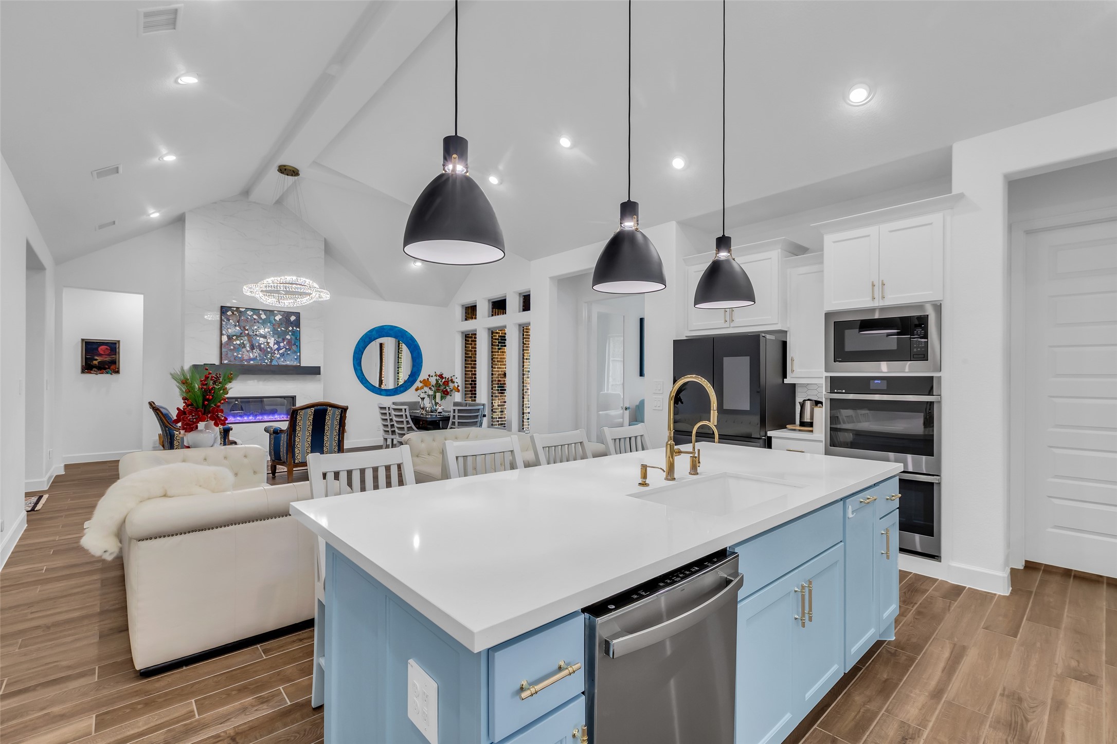 633 North Rivus Overlook Drive Willis, TX 77318 - Photo 14 of 28 a kitchen with stainless steel appliances a stove a sink a oven and white cabinets with wooden floor