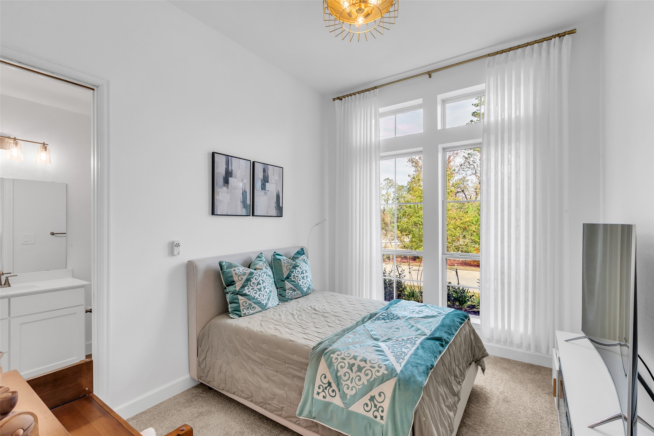 633 North Rivus Overlook Drive Willis, TX 77318 - Photo 20 of 28 a bedroom with a bed and a window