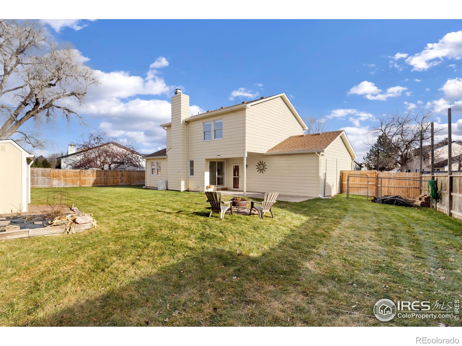 3367 Dudley Way Fort Collins, CO 80526 - Photo 22 of 29 a backyard of a house with table and chairs