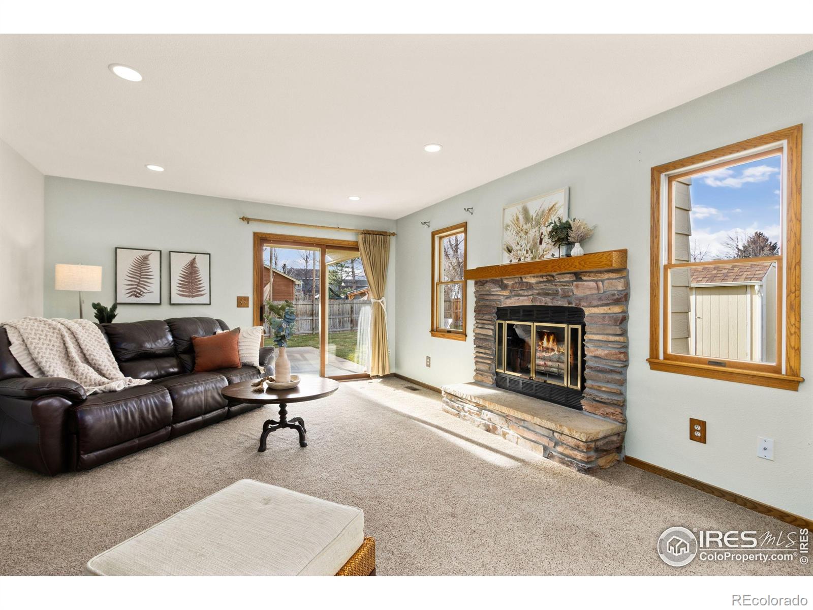 3367 Dudley Way Fort Collins, CO 80526 - Photo 4 of 29 a living room with furniture a window and a fireplace