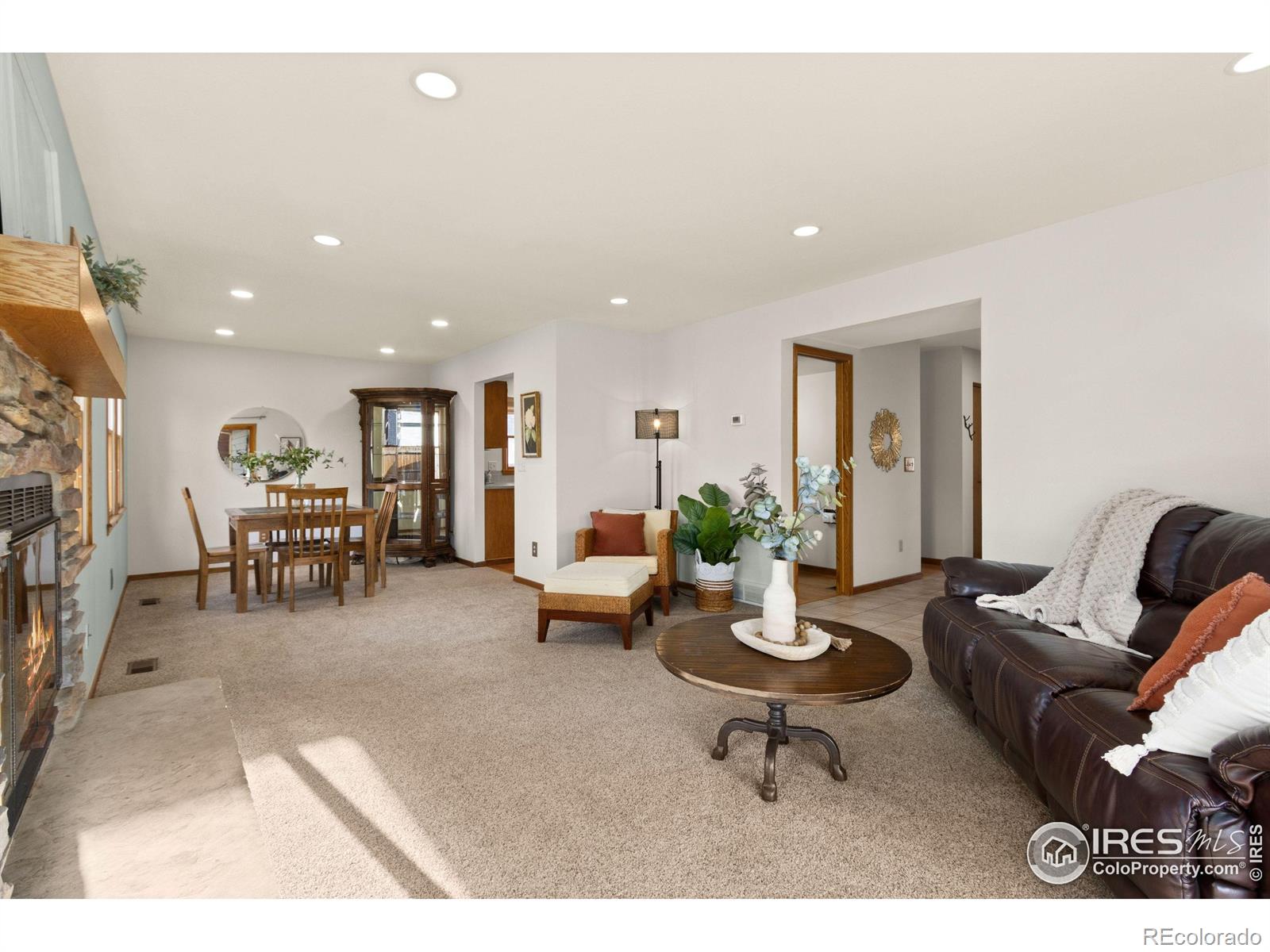 3367 Dudley Way Fort Collins, CO 80526 - Photo 5 of 29 a living room with furniture a wooden floor and a fireplace