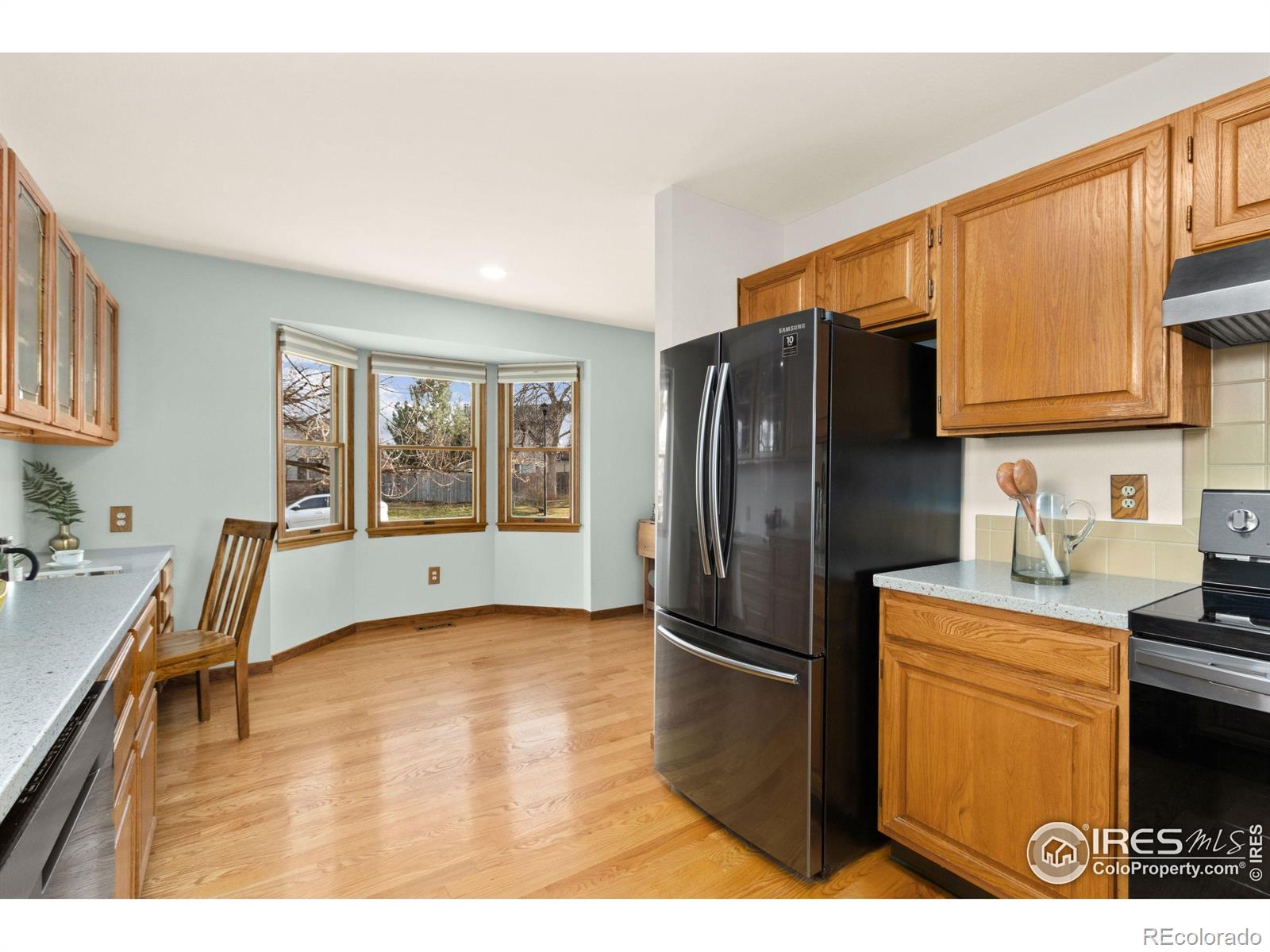 3367 Dudley Way Fort Collins, CO 80526 - Photo 8 of 29 a kitchen with stainless steel appliances granite countertop a refrigerator a stove top oven a sink and dishwasher