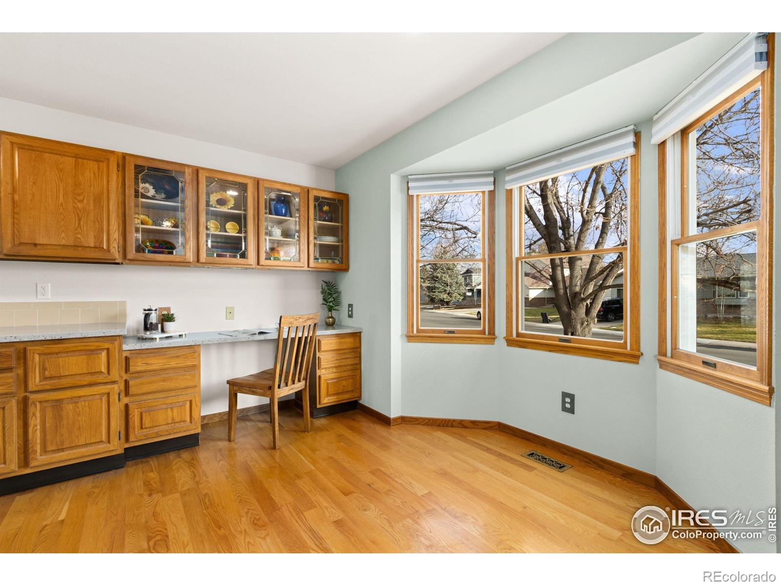 3367 Dudley Way Fort Collins, CO 80526 - Photo 9 of 29 a kitchen with a window wooden cabinets and dining table