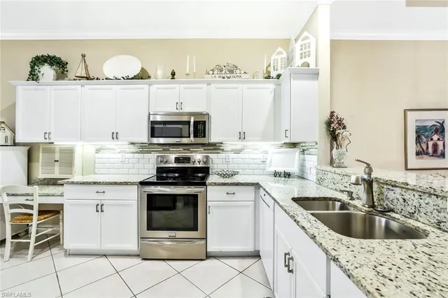 a kitchen with granite countertop a sink and cabinets
