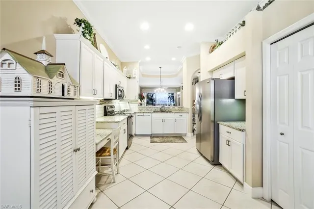 a kitchen with cabinets and chairs