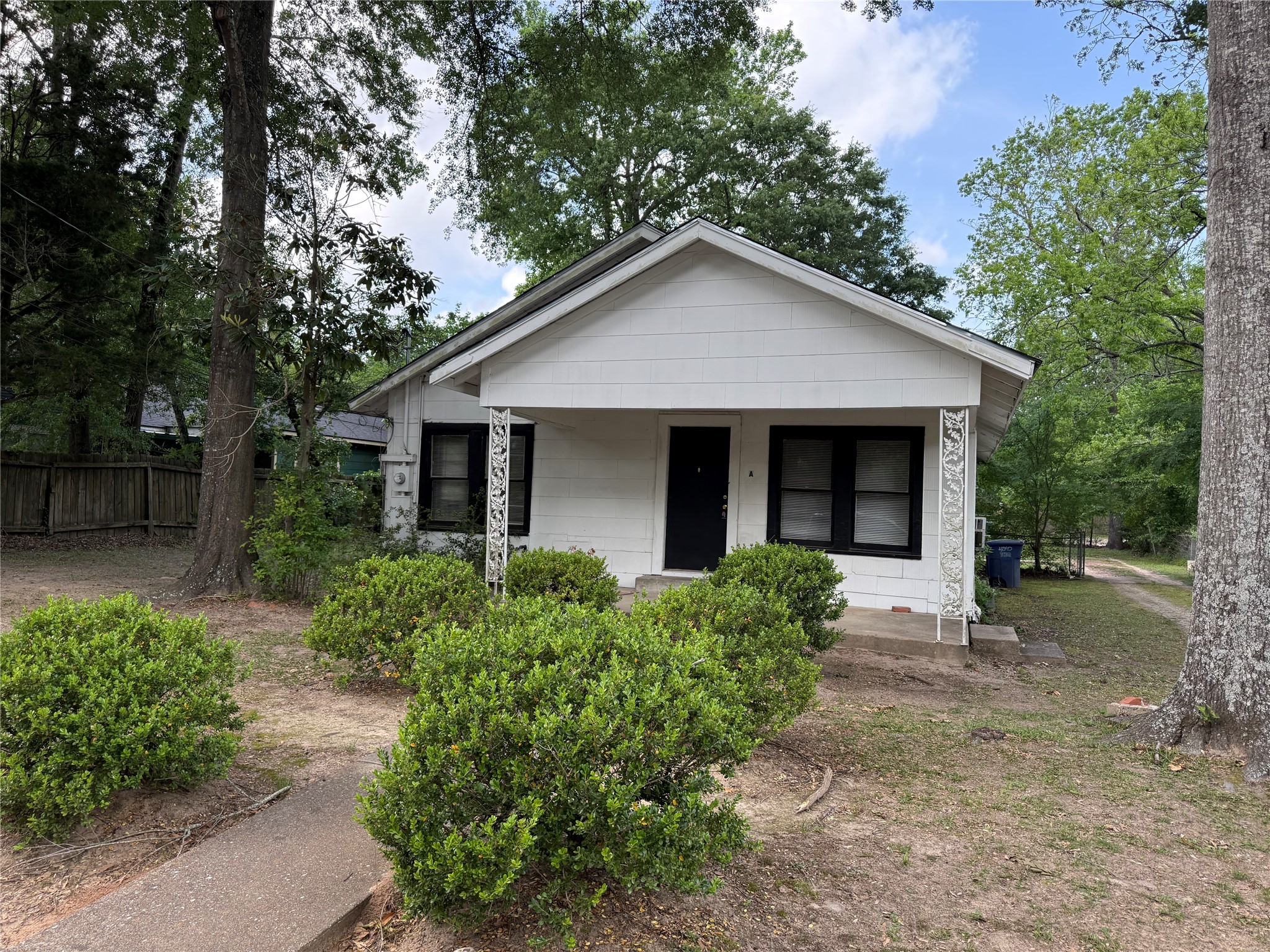 2812 Angier Road Huntsville, TX 77340 - Photo 1 of 6 a front view of a house with yard and green space