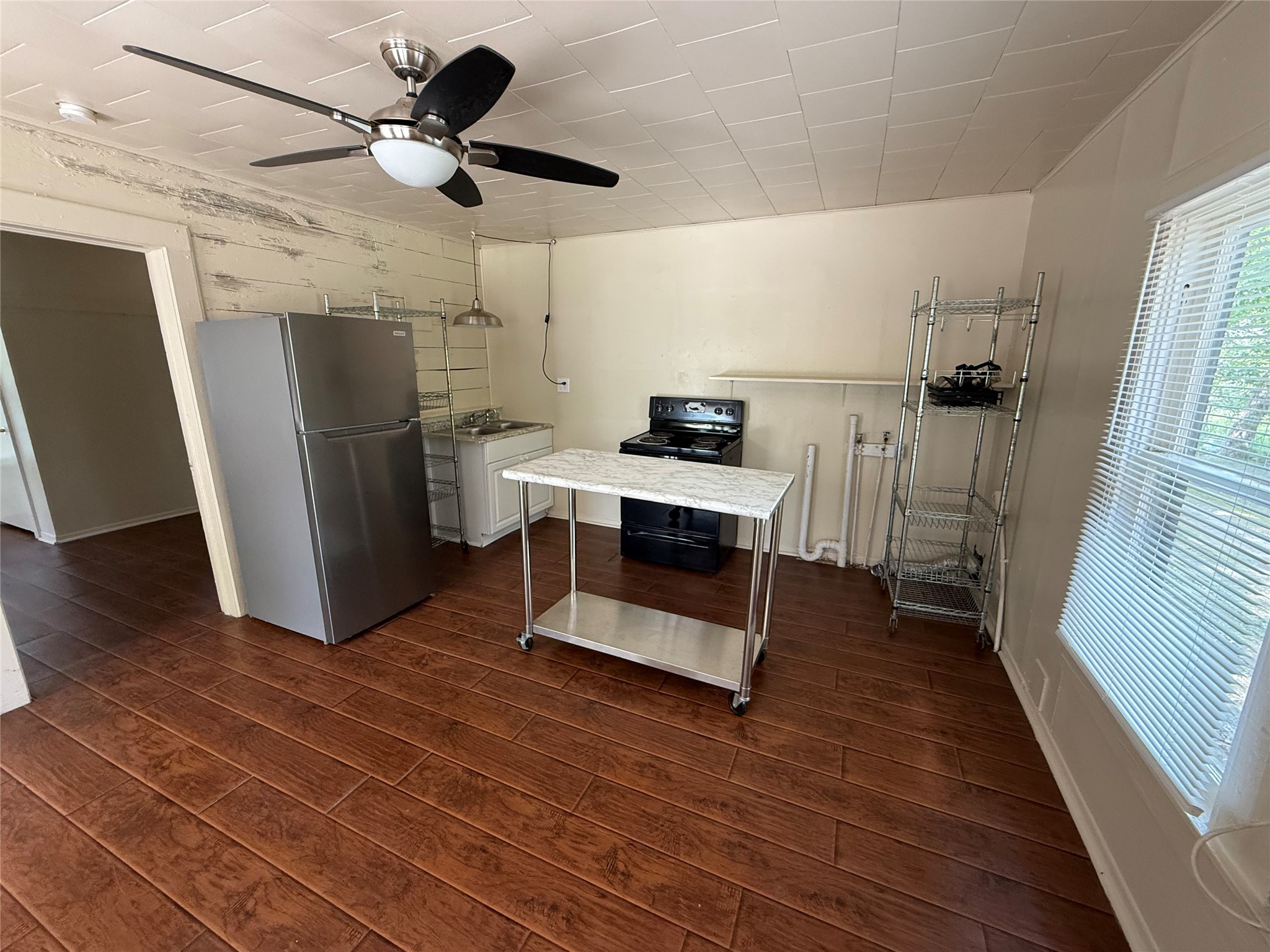 2812 Angier Road Huntsville, TX 77340 - Photo 3 of 6 a view of a kitchen with refrigerator and a ceiling fan
