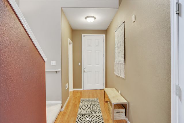 a view of a hallway with furniture and stairs
