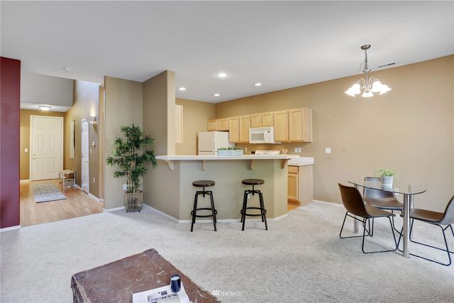 a living room with furniture a fireplace and a large window
