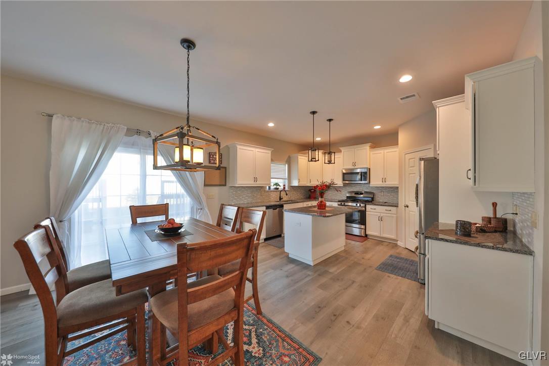 11 Krocks Road Allentown, PA 18104 - Photo 11 of 49 a view of a dining room and livingroom with furniture wooden floor a chandelier