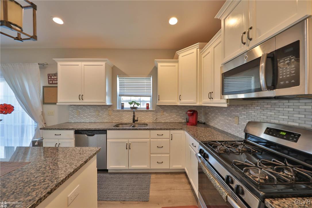 11 Krocks Road Allentown, PA 18104 - Photo 12 of 49 a kitchen with stainless steel appliances granite countertop a stove a sink and a microwave