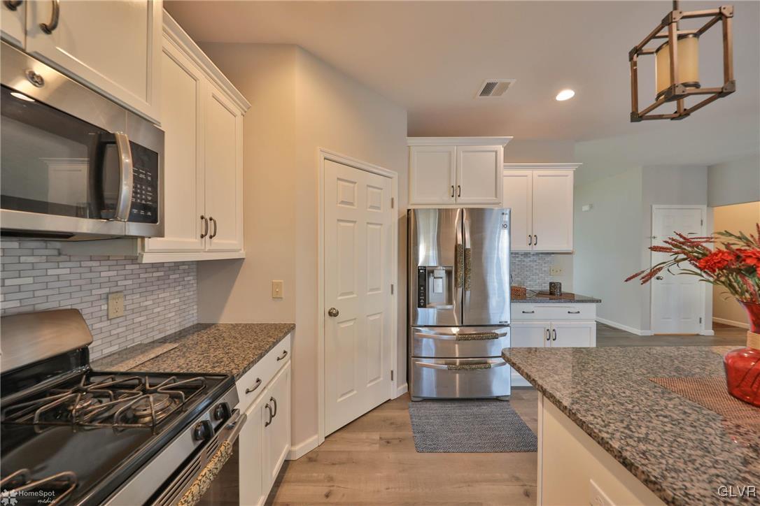 11 Krocks Road Allentown, PA 18104 - Photo 13 of 49 a kitchen with stainless steel appliances granite countertop a stove and a refrigerator