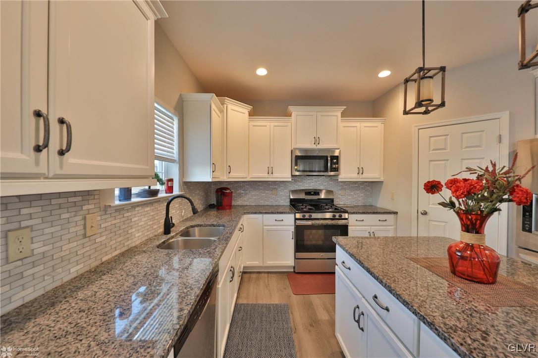 11 Krocks Road Allentown, PA 18104 - Photo 15 of 49 a kitchen with stainless steel appliances granite countertop a sink stove and cabinets