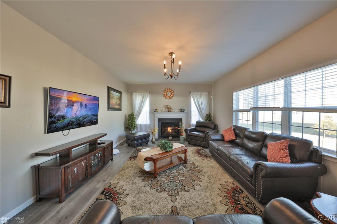 11 Krocks Road Allentown, PA 18104 - Photo 18 of 49 a living room with furniture a fireplace and a flat screen tv