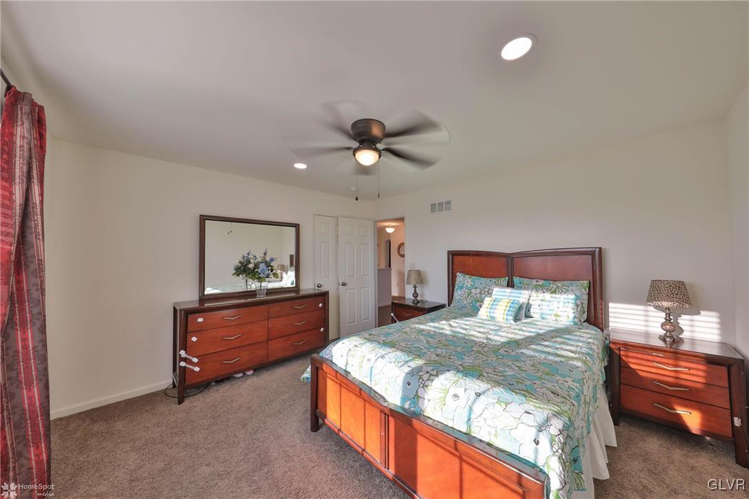 11 Krocks Road Allentown, PA 18104 - Photo 26 of 49 a bedroom with a bed and a chandelier