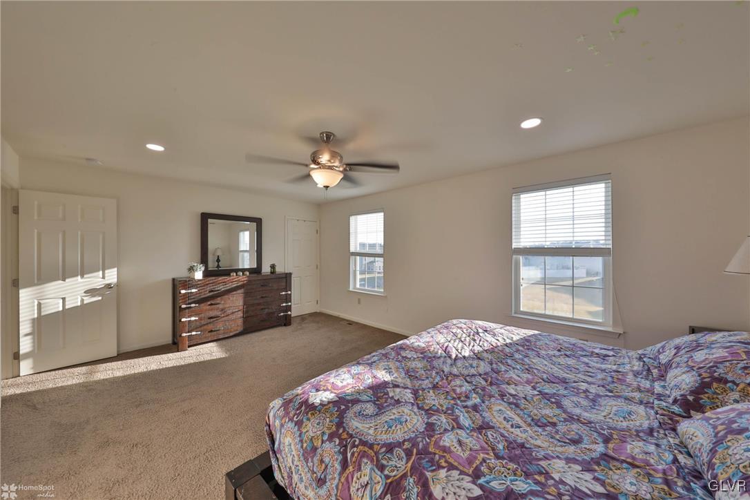 11 Krocks Road Allentown, PA 18104 - Photo 33 of 49 a spacious bedroom with a large bed and a flat tv screen