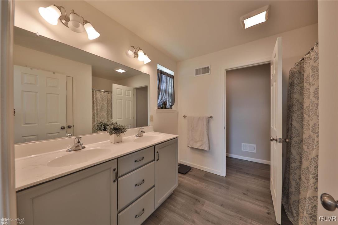 11 Krocks Road Allentown, PA 18104 - Photo 34 of 49 a bathroom with a double vanity sink a mirror and shower