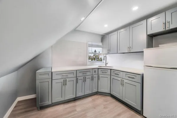 a kitchen with cabinets a sink and white stainless steel appliances
