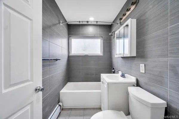 a bathroom with a toilet a sink and bathtub