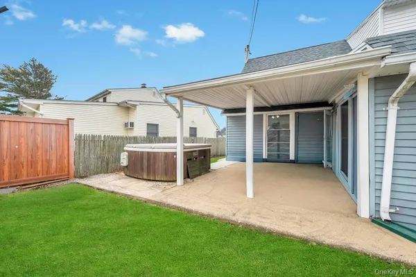 a view of a house with a yard and porch
