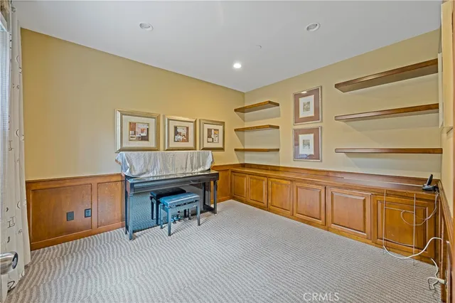 a view of a living room with wooden floor and a large window
