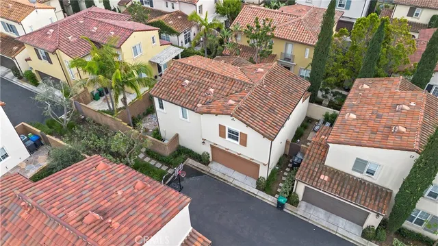 an aerial view of a house with garden space and street view