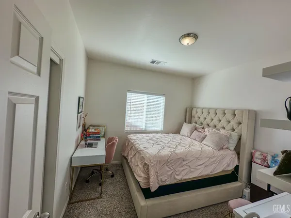 a bedroom with a bed and a dresser in it