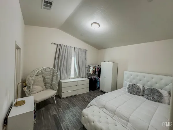 a bedroom with a bed and a large window